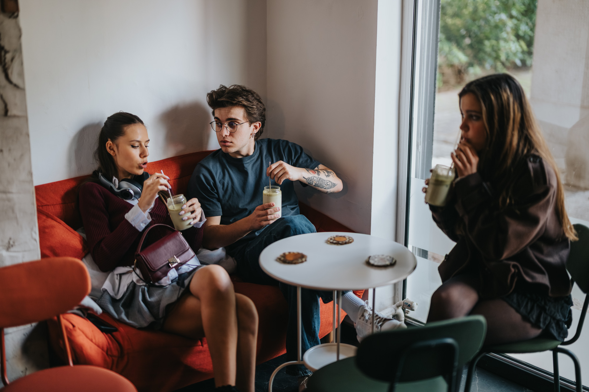 Three friends sitting together in a cafe
