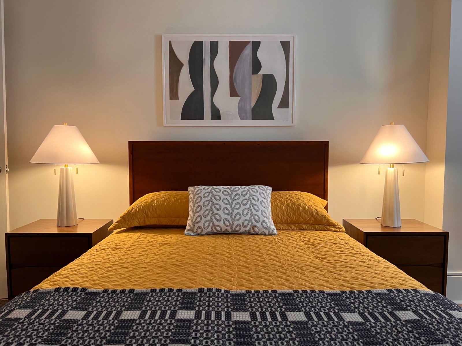 Full-size bed in a model bedroom at Baker House