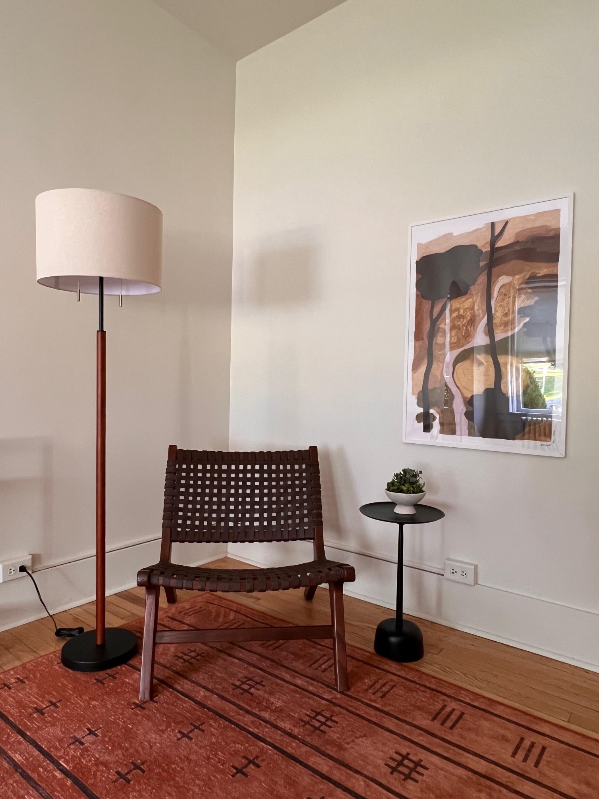 Detail of an armchair and artwork in a model living room at Baker House